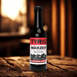 una botella de cerveza Tyris Märzen Sin Gluten sobre una mesa, con 5,5 grados de alcohol, ideal para personas alérgicas al gluten