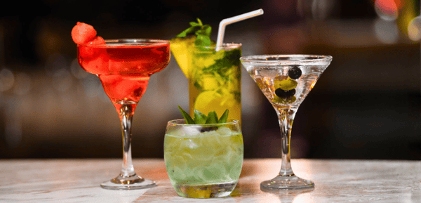 Varias copas con cócteles con ginebra, recetas clásicas y deliciosas para beber.