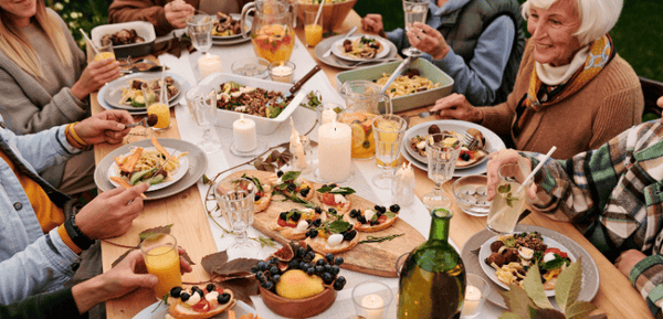 Mesa familiar con comida gourmet y platos variados para celebrar el Día de la Madre disfrutando de un banquete completo en la mejor compañía