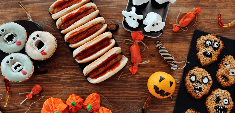 Una mesa llena de comida y aperitivos para celebrar Halloween de forma creativas con ideas deliciosas y llamativas en forma de fantasmas, monstruos, calaveras y momias.