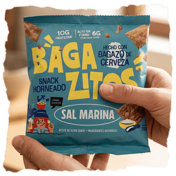 Una persona con bolsa de Bagazitos en las manos, un snack horneado con aceite de oliva que cuida de tu salud y del planeta a partes iguales.